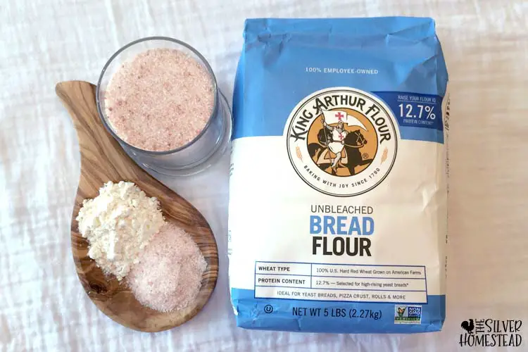 bread flour and pink Himalayan salt on a white farmhouse table