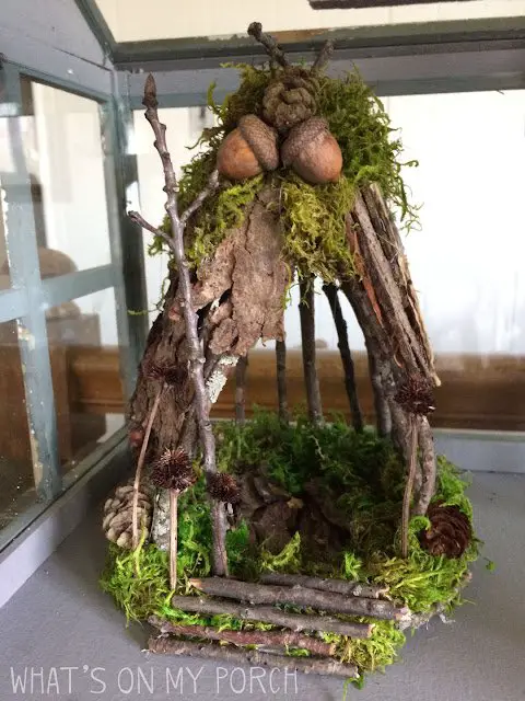 A cute fairy house made of sticks, moss and acorns